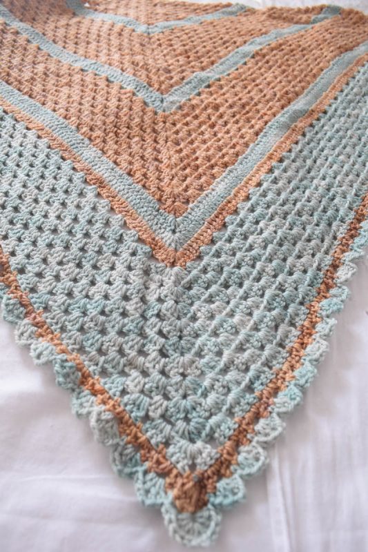 Free crochet pattern: Journey Shawl in Sweet Georgia Tough Love Sock yarn by Underground Crafter | Take a peaceful journey with this beginner-friendly triangular shawl, which is also lightweight enough to wear as a triangular scarf.